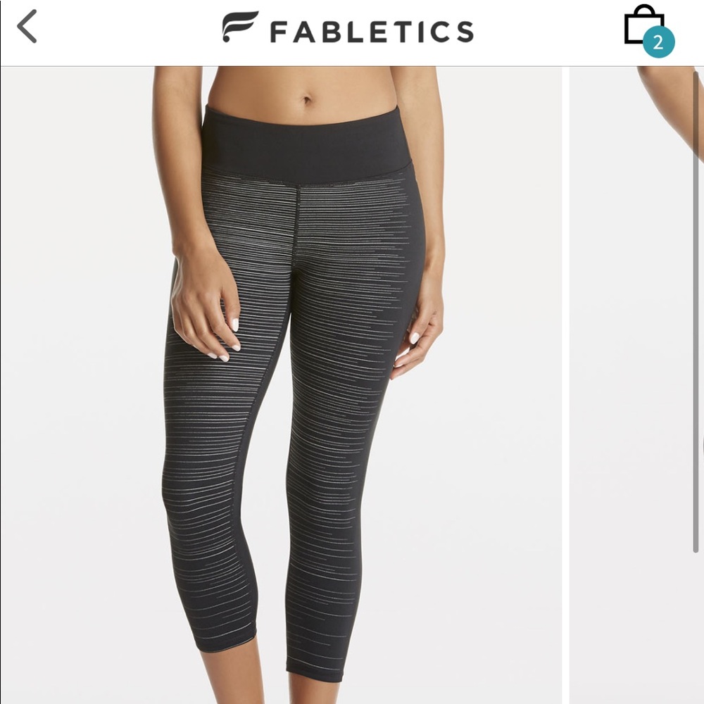 Fabletics crop black leggings with subtle reflective front design. SMALL